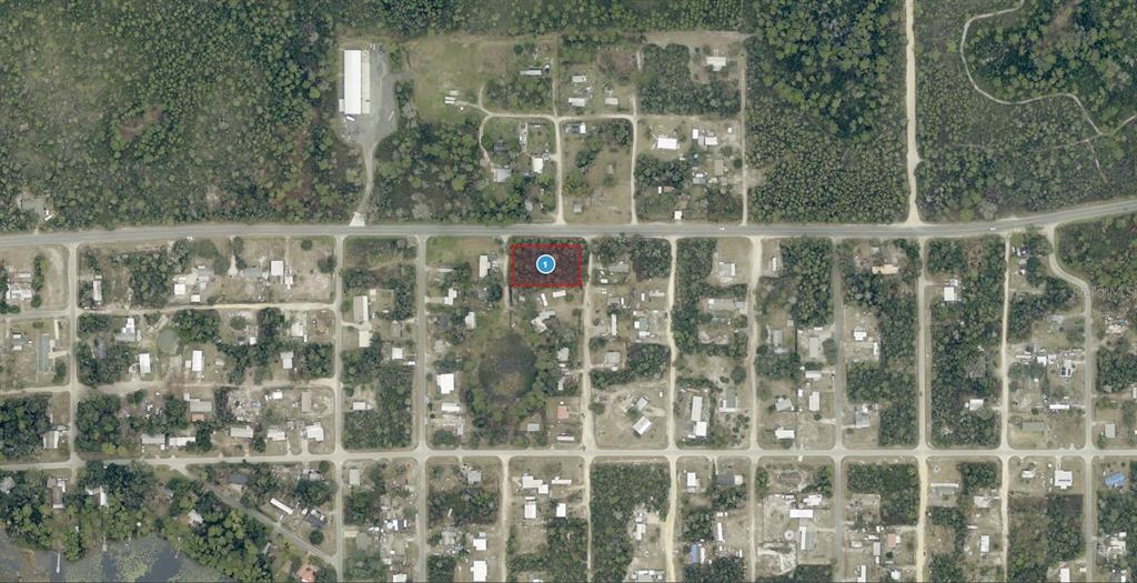 This is an aerial map view showing a rectangular lot highlighted in red — 28108 COUNTY ROAD 42, PAISLEY, FL