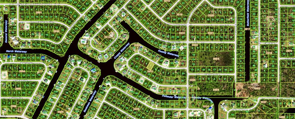 This is an aerial map showing residential lots and waterways in a suburban neighborhood — 12359 CORPORAL CIRCLE, PORT CHARLOTTE, FL
