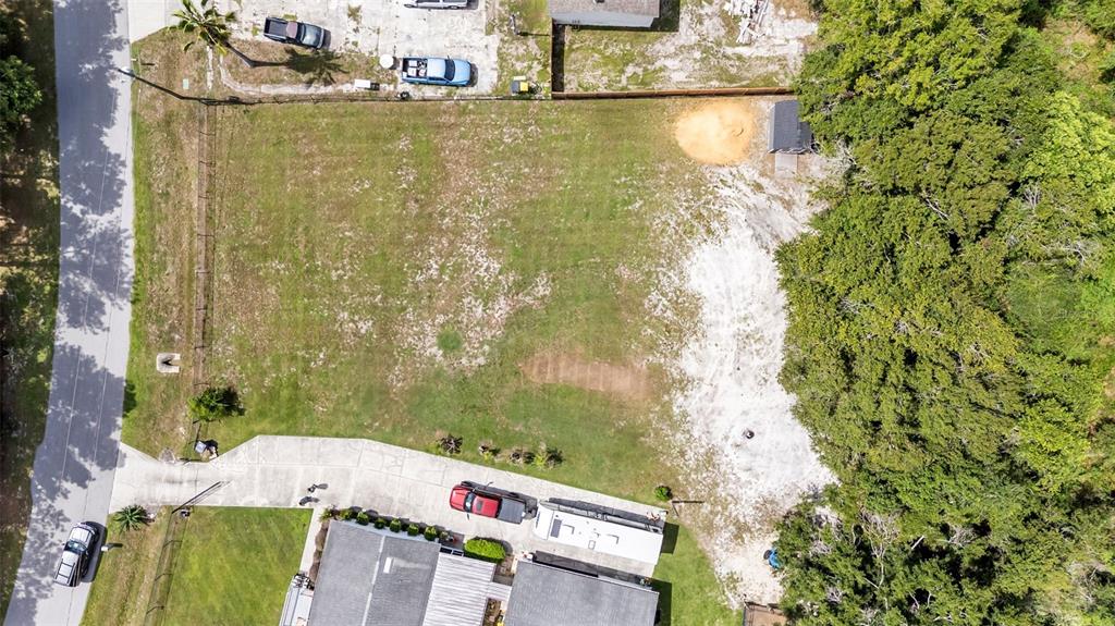 An aerial view shows a rectangular vacant lot with a small shed and nearby trees — 3632 LAUREL CREST DRIVE, MULBERRY, FL
