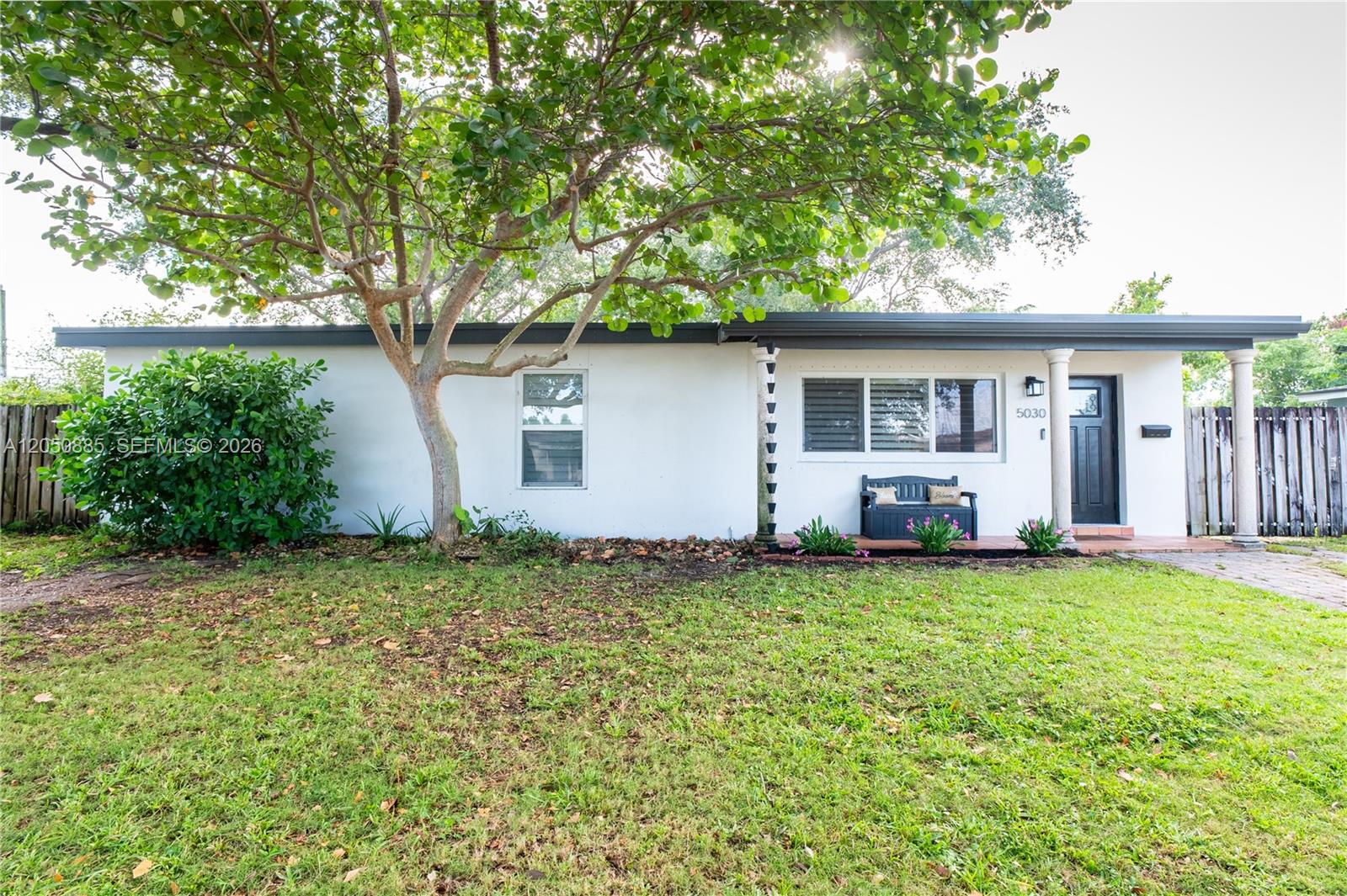 A single-story white house with a flat roof, a large tree, and a front bench — 5030 SW 113th Ct, Miami FL 33165, MIAMI, FL