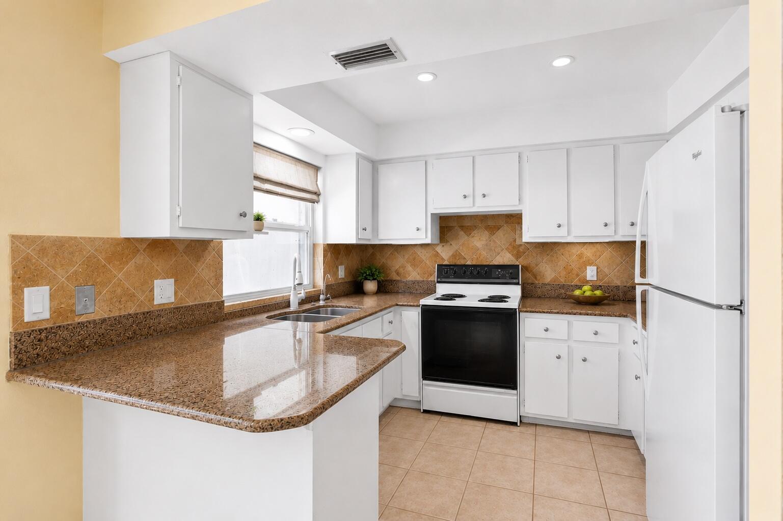 A kitchen with white cabinets, granite countertops, a black stove, and tan tile backsplash — 1029 Arabian Drive, Loxahatchee FL 33470, LOXAHATCHEE, FL