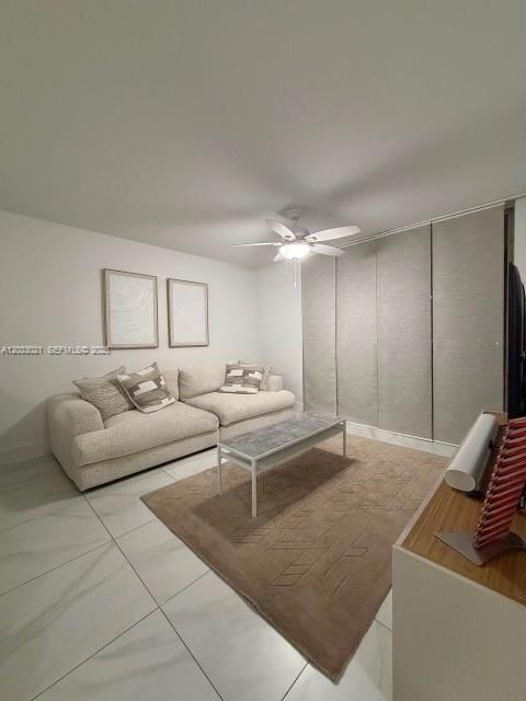 A living room features a white sectional sofa, a coffee table, and a ceiling fan — 4540 NW 107th Ave # 11, Doral FL 33178, DORAL, FL