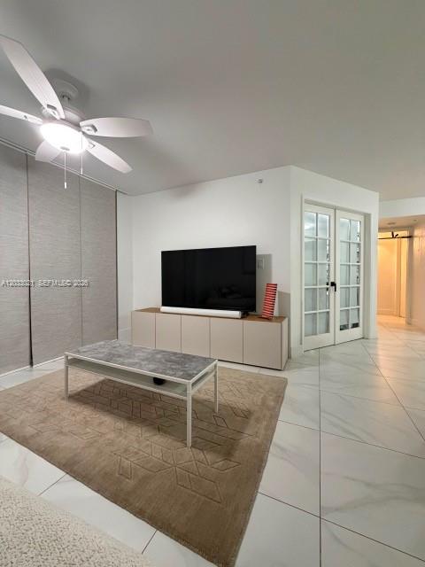 A living room features a ceiling fan, a television on a console, and tiled floors — 4540 NW 107th Ave # 11, Doral FL 33178, DORAL, FL