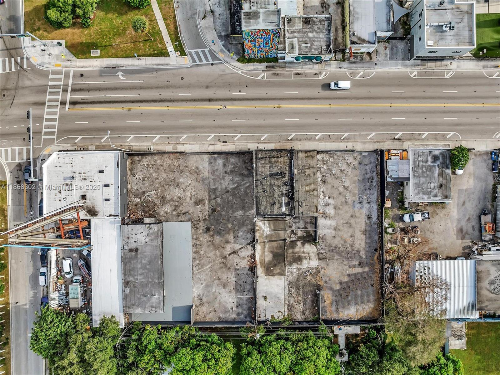 An aerial view shows a vacant urban lot with building foundations and a construction crane — 570 NW 54th St, Miami FL 33127, MIAMI, FL