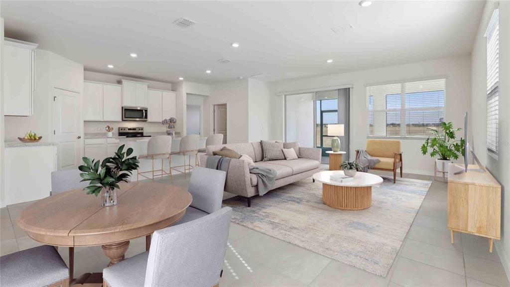 This is a digital rendering of an open-concept living area with a kitchen and dining space — 8171 IVES PLACE, WILDWOOD, FL