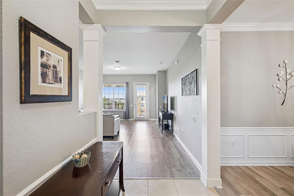 A view from a tiled entryway looking through a columned opening into a living area — 4816 CAYVIEW AVENUE UNIT 40111, ORLANDO, FL