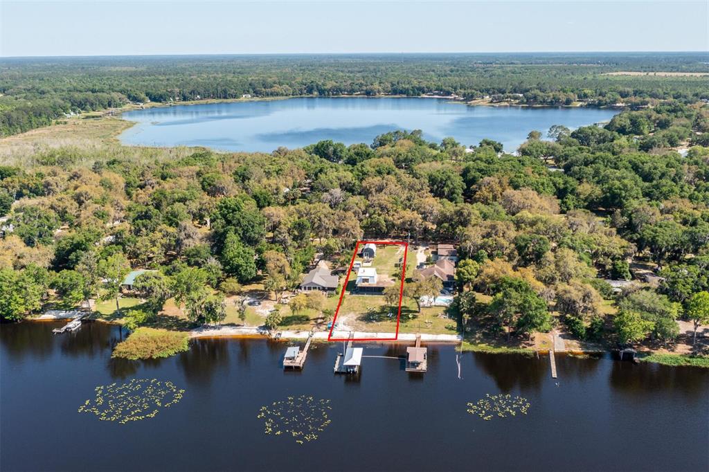 An aerial view shows a waterfront property with a red-outlined lot and private docks — 120 LITTLE ORANGE LAKE DRIVE, HAWTHORNE, FL