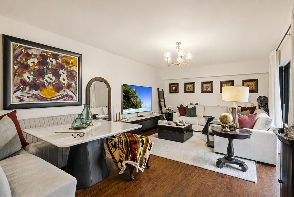 A living and dining room featuring a marble table, white sofa, and wall-mounted television — 7707 77th Way # 7707, West Palm Beach FL 33407, WEST PALM BEACH, FL