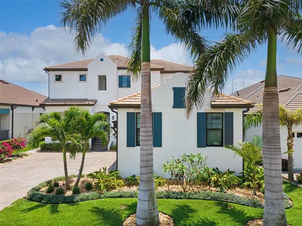 A two-story white stucco house with a tile roof and palm trees in the yard — 3028 CHRISTOPHERS WATCH LANE, RUSKIN, FL