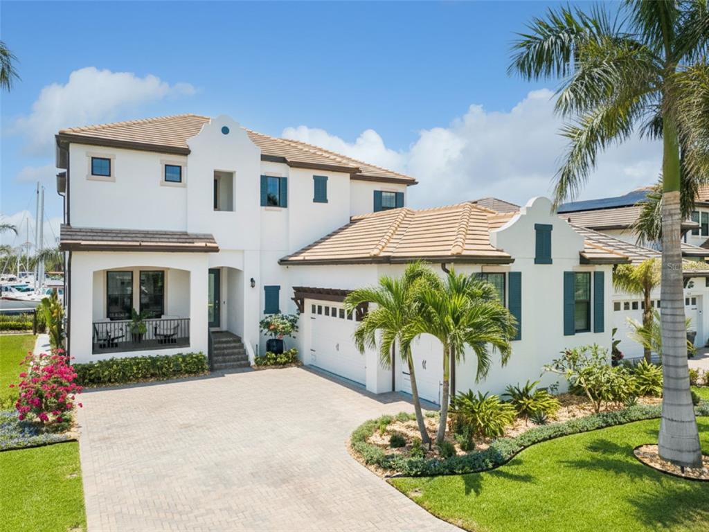 A two-story white stucco house with a tile roof, garage, and paved driveway — 3028 CHRISTOPHERS WATCH LANE, RUSKIN, FL