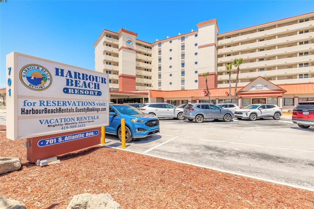 The exterior of the Harbour Beach Resort features a multi-story building with a parking lot — 701 S ATLANTIC AVENUE UNIT 417, DAYTONA BEACH, FL