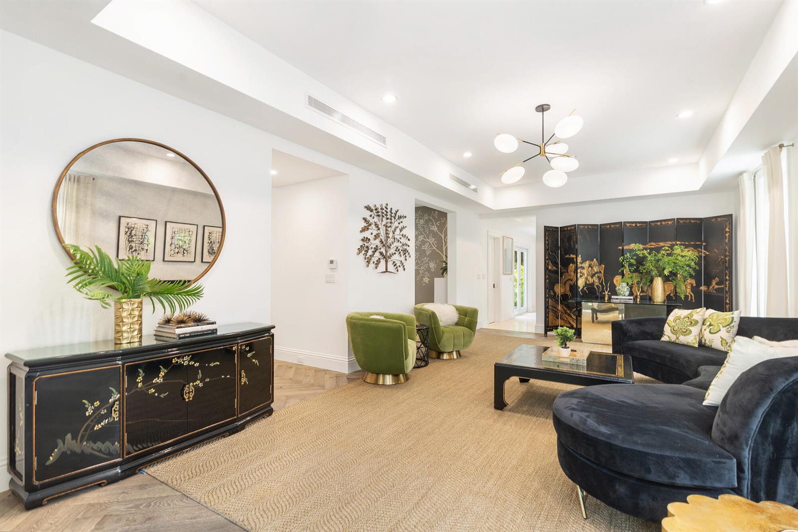 A living room features a black lacquer sideboard, green armchairs, and a dark curved sofa — 443 Seaview Avenue, Palm Beach FL 33480, PALM BEACH, FL