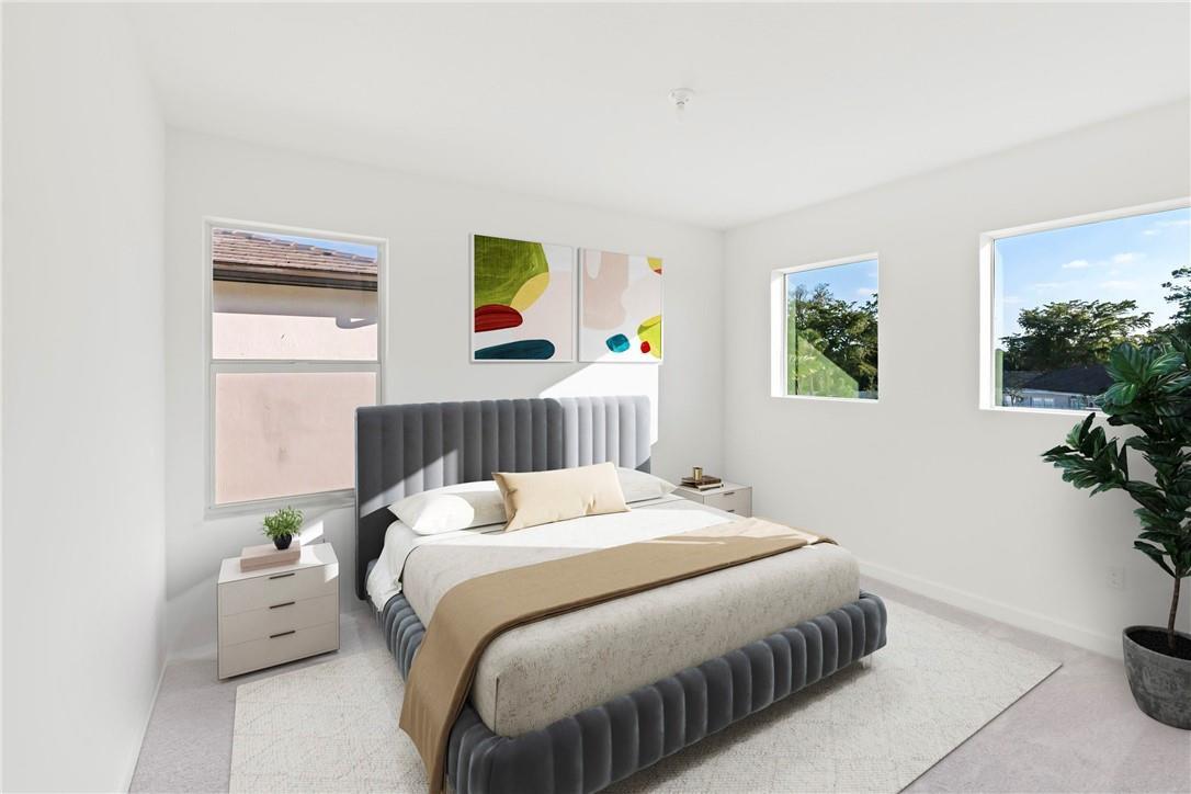 A bedroom features a gray upholstered bed, two nightstands, and abstract wall art — 22974 Hillshire Road, Boca Raton FL 33433, BOCA RATON, FL