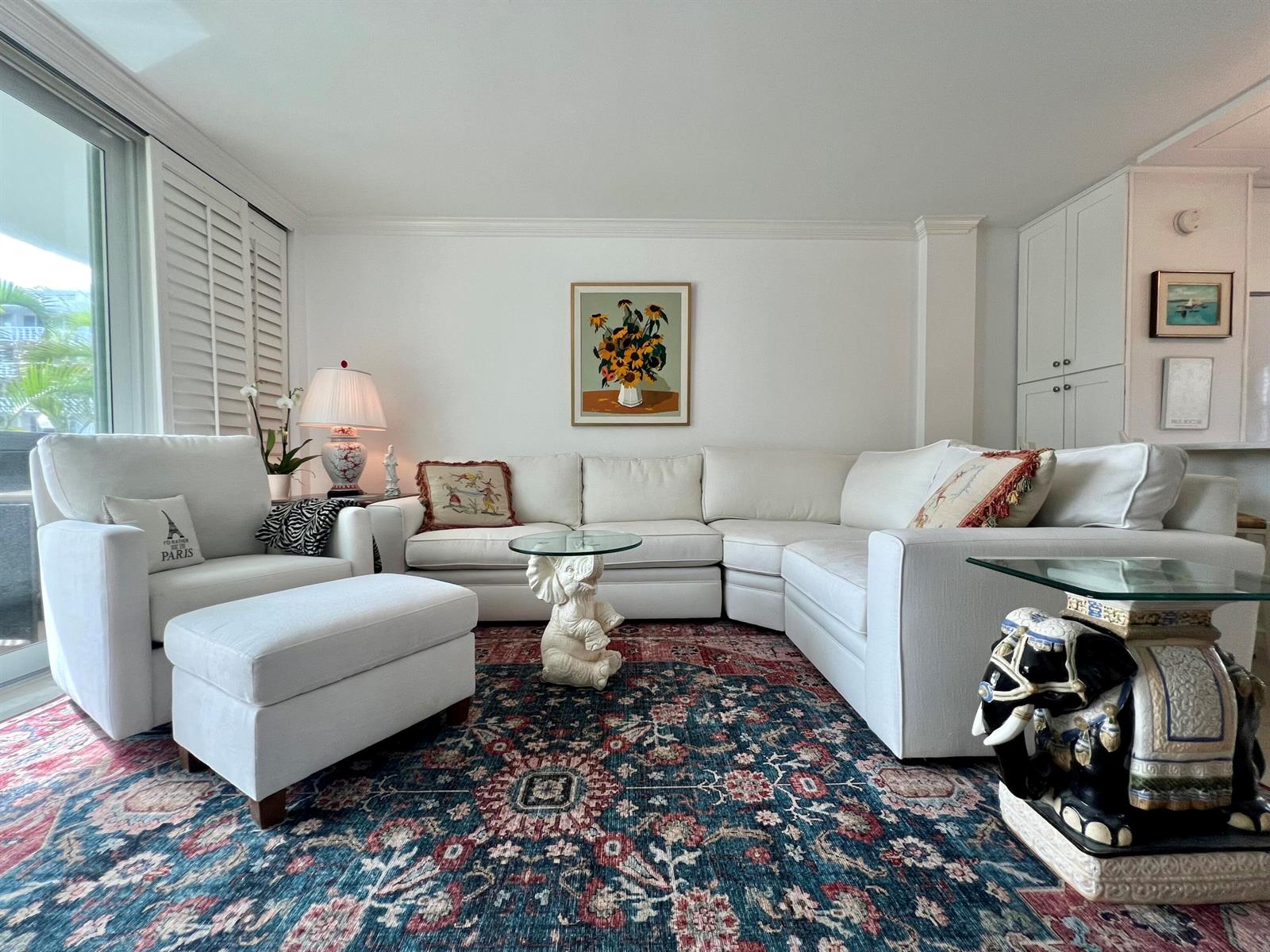 A living room features a white sectional sofa, an armchair with ottoman, and a patterned rug — 139 Sunrise Avenue # 204, Palm Beach FL 33480, PALM BEACH, FL