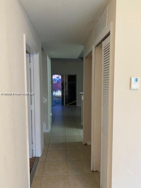 A two-story townhouse with a brown garage door, a small balcony, and a front lawn — 646 SW 7th Ter, Florida City FL 33034, FLORIDA CITY, FL