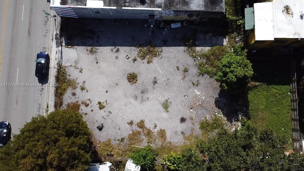An aerial view shows a vacant, unpaved rectangular lot situated between two buildings — 4120 NW 17th Ave, Miami FL 33142, MIAMI, FL