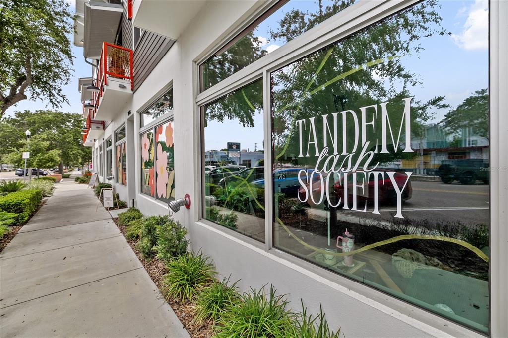 The exterior of a commercial building features large glass windows with white signage — 17 29TH STREET N Lot 8, ST PETERSBURG, FL