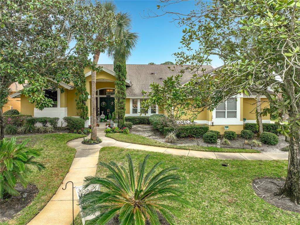 A yellow single-story house with a paved walkway, palm trees, and landscaped front yard — 635 CHOCKTAW STREET, LAKE MARY, FL