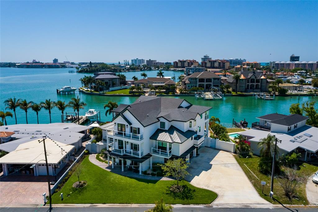 An aerial view of a multi-story white house with a dark roof near the water — 5408 PALI WAY, ST PETE BEACH, FL