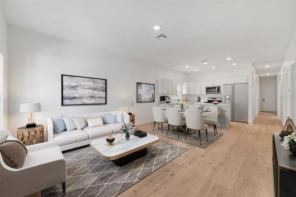 This is a digital rendering of an open-concept living room and kitchen with light flooring — 1724 ELIZABETH AVENUE, TITUSVILLE, FL