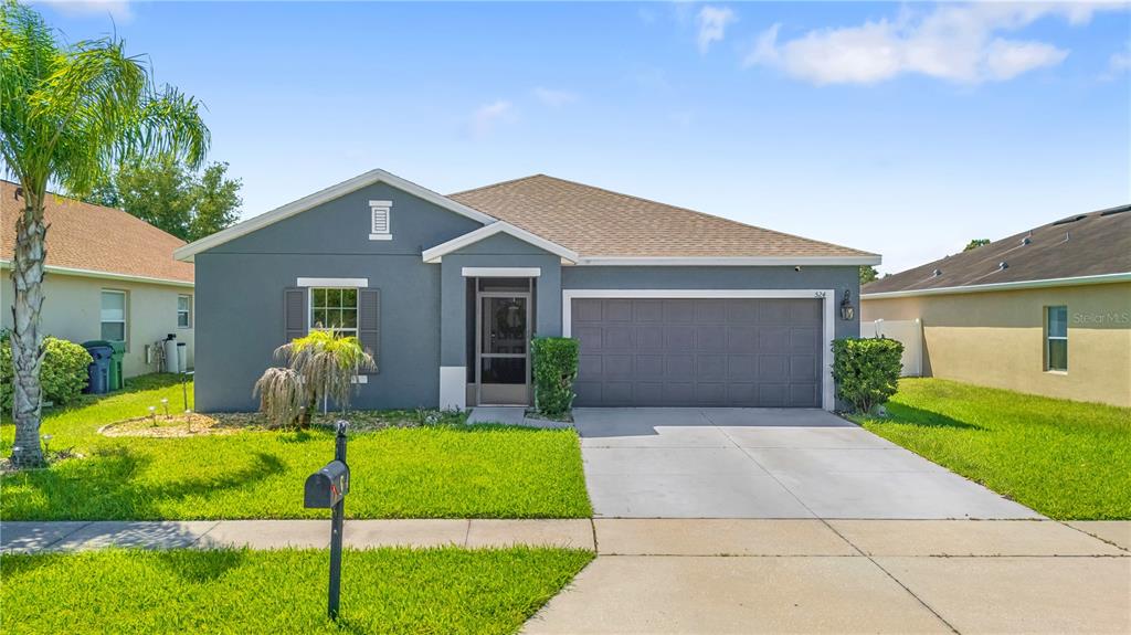 A single-story gray house with a two-car garage and a front lawn — 524 HAINES TRAIL, WINTER HAVEN, FL