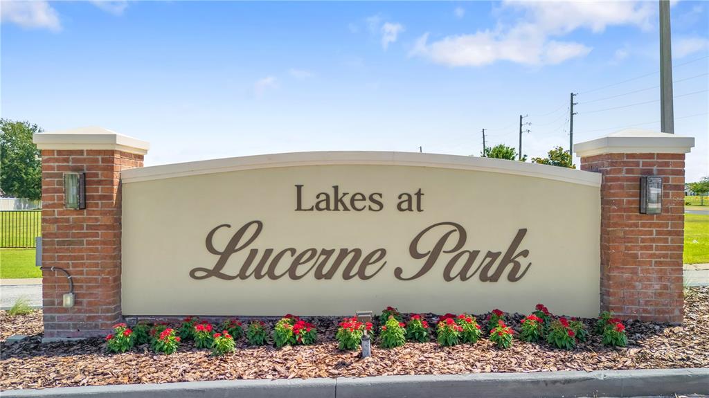 A brick-columned monument sign displays the name Lakes at Lucerne Park in a landscaped area — 524 HAINES TRAIL, WINTER HAVEN, FL