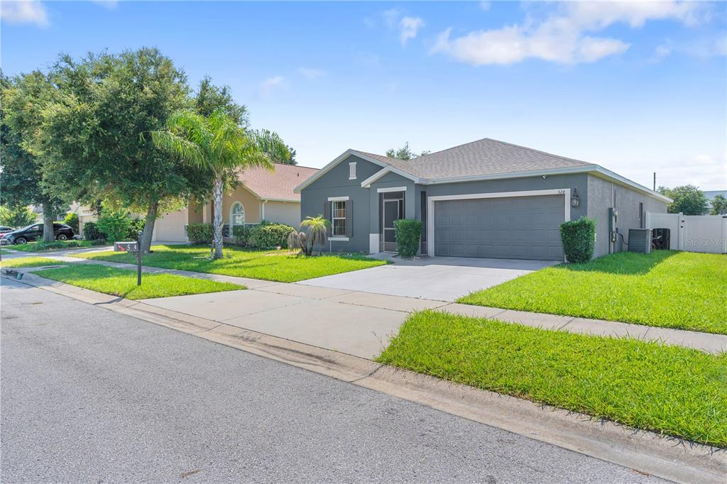 A gray single-story house with a two-car garage and a front lawn — 524 HAINES TRAIL, WINTER HAVEN, FL
