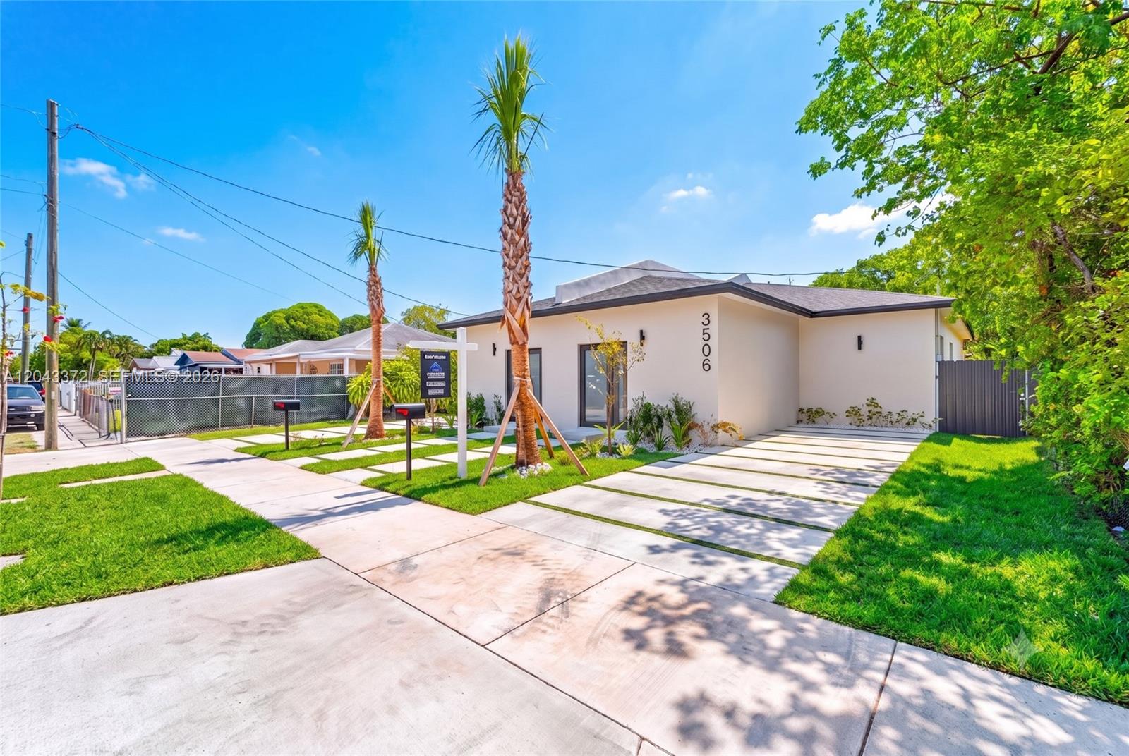 A single-story house with a modern facade, palm trees, and a concrete driveway — 3506 NW 9th Ave, Miami FL 33127, MIAMI, FL