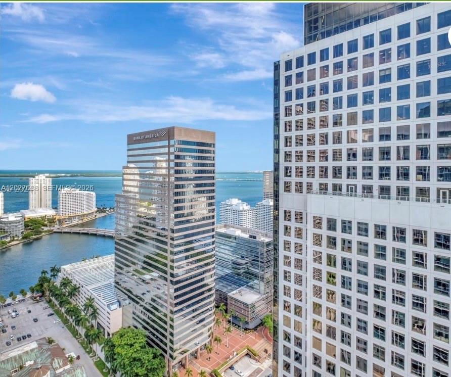 An aerial view of a city skyline featuring modern glass skyscrapers near a waterfront — 500 Brickell Ave # 3910, Miami FL 33131, MIAMI, FL