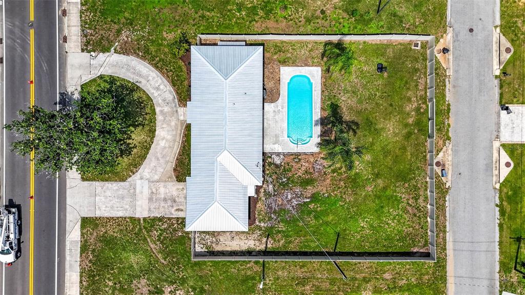 An aerial view shows a house with a metal roof, pool, and fenced yard — 37121 MERIDIAN AVENUE, DADE CITY, FL
