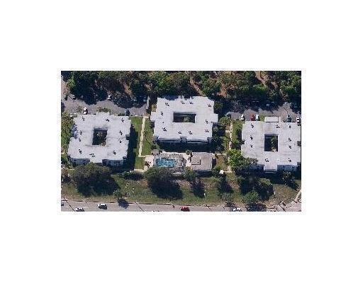 An aerial view shows three square apartment buildings with central courtyards and a swimming pool — 2302 Sunrise Boulevard # 104, Fort Pierce FL 34982, FORT PIERCE, FL