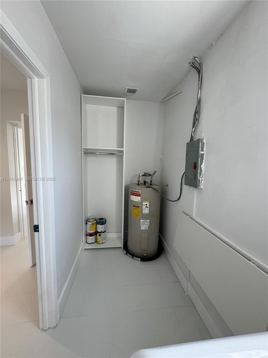 A utility closet contains a water heater, an electrical panel, and a tall storage unit — 951 E 32nd St, Hialeah FL 33013, HIALEAH, FL
