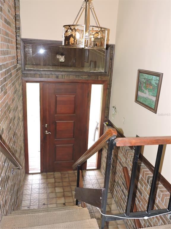 A brown two-story house with a metal roof and an attached carport sits on land — 5757 TRASK ROAD, FORT MEADE, FL