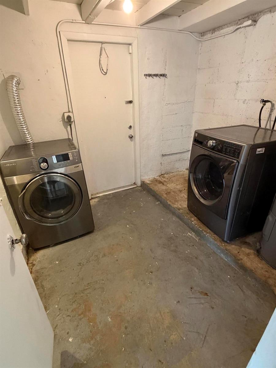 A laundry room features two stainless steel appliances on a concrete floor with block walls — 6129 SW 22nd Street, Miramar FL 33023, MIRAMAR, FL