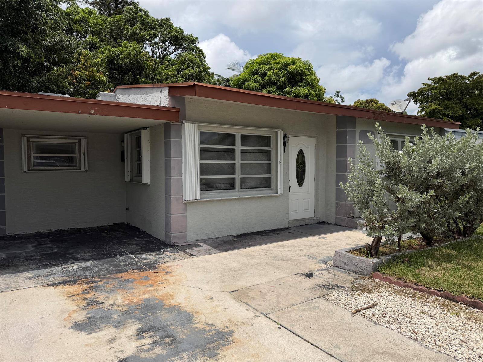 A single-story house with a carport, light gray exterior, and a white front door — 6129 SW 22nd Street, Miramar FL 33023, MIRAMAR, FL