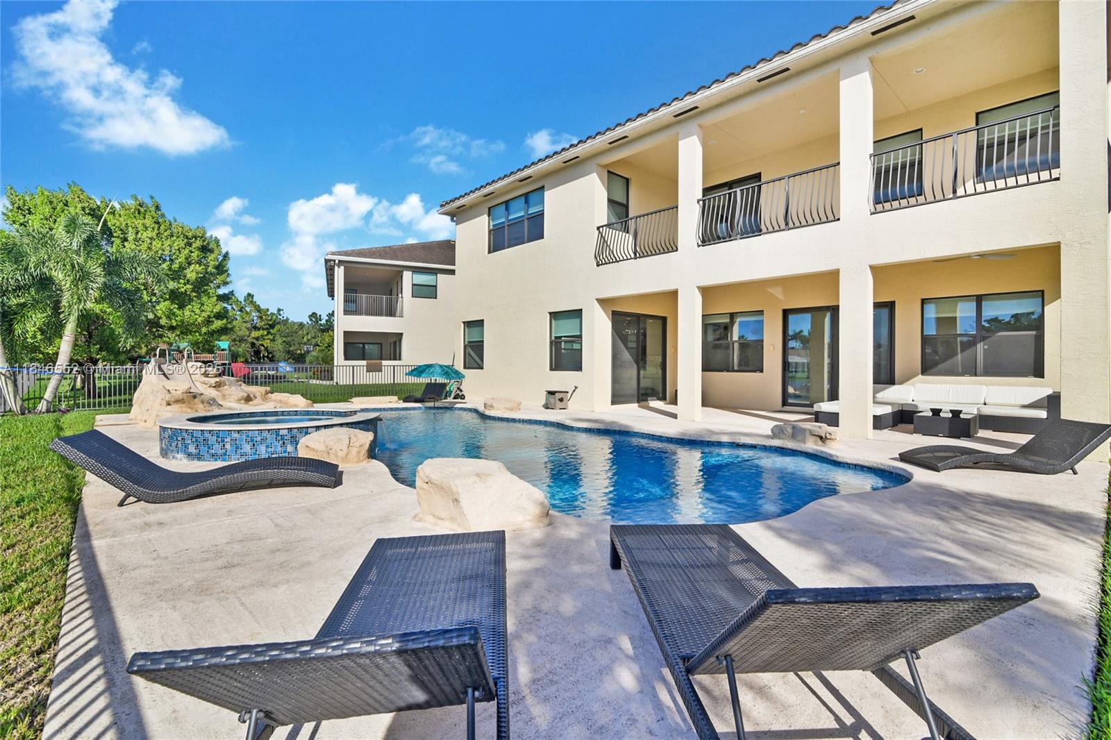 A two-story house with a pool, spa, and lounge chairs on a concrete patio — 12137 Boca Reserve Ln, Boca Raton FL 33428, BOCA RATON, FL