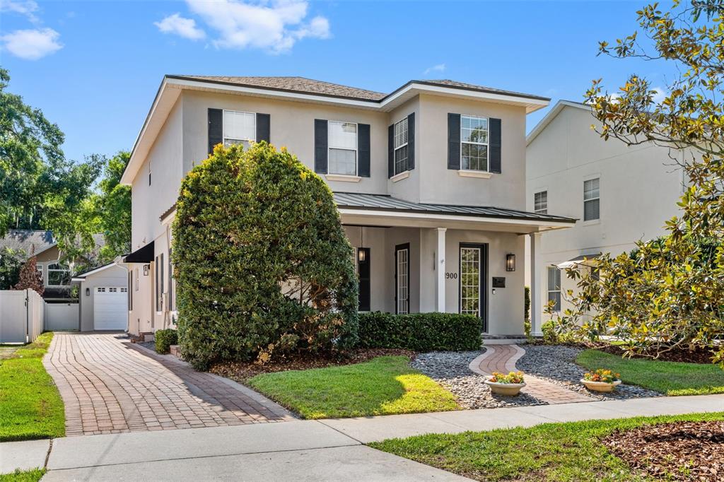 A two-story house features a paved driveway, a front porch, and a landscaped front yard — 1900 GERDA TERRACE, ORLANDO, FL