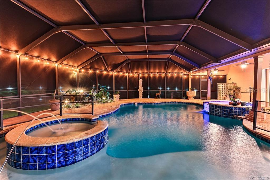A screened-in pool area features a raised hot tub with a fountain and blue tiles — 5215 N HONEYCREEK TERRACE, CRYSTAL RIVER, FL