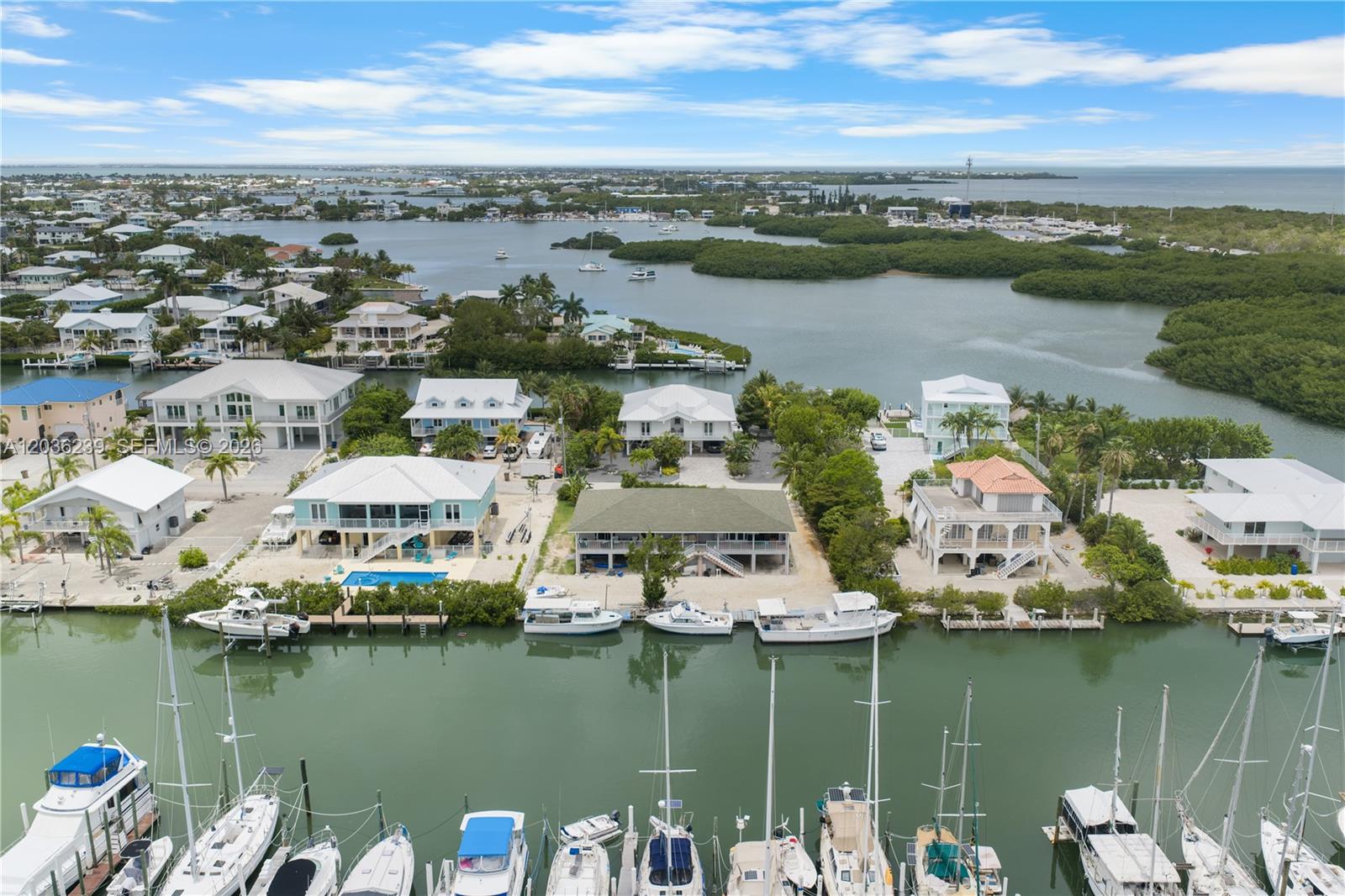 An aerial view shows waterfront houses with private docks and boats along a canal — 2100 Avenue H, Marathon FL 33050, MARATHON, FL