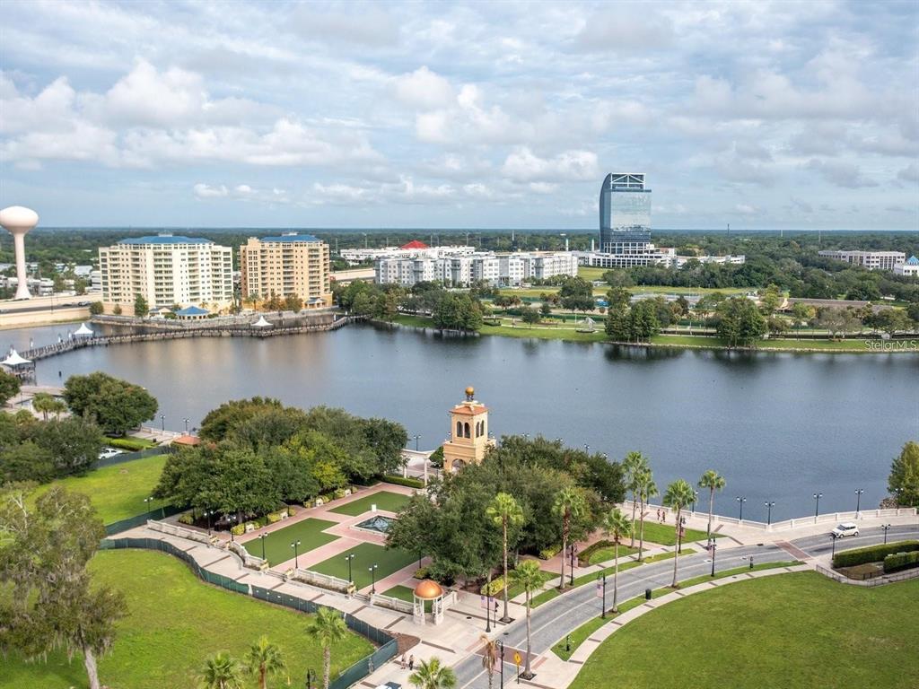 An aerial view shows a lakefront park with a clock tower, buildings, and a skyscraper — 120 BLUE POINTE WAY UNIT 340, ALTAMONTE SPRINGS, FL