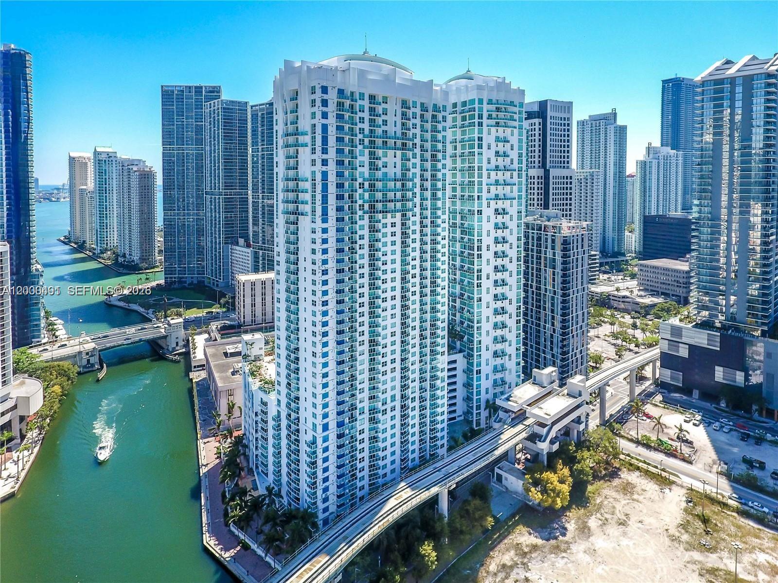 An aerial view of a tall residential skyscraper in Miami next to a river — 31 SE 5th St # 4212, Miami FL 33131, MIAMI, FL