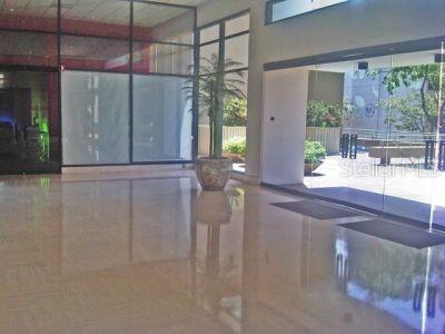 A bright lobby features polished tile floors, large glass windows, and a potted palm plant — 431 PONCE DE LEON AVE., SAN JUAN, PR