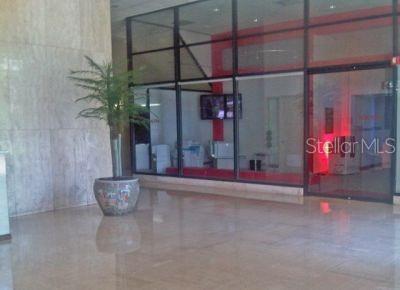 A lobby area features a potted plant, marble flooring, and glass walls looking into an office — 431 PONCE DE LEON AVE., SAN JUAN, PR