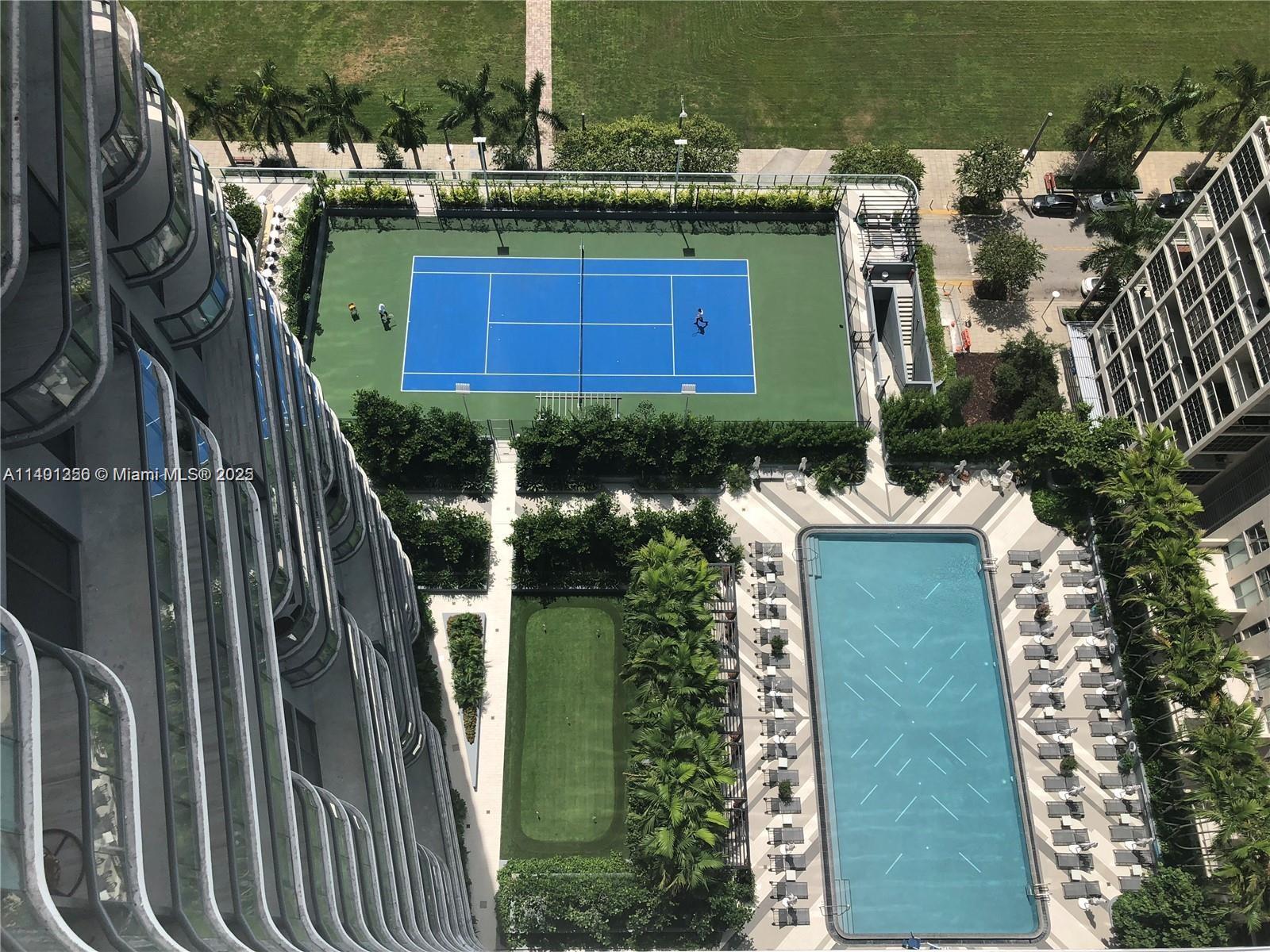 An aerial view shows a tennis court, a swimming pool, and a putting green — 121 NE 34 St # 2215, Miami FL 33137, MIAMI, FL