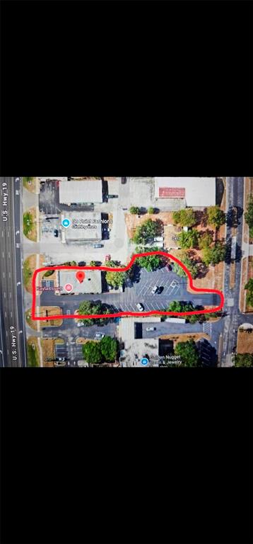 This aerial map shows a commercial property with a building and parking lot outlined in red — 2404 US HIGHWAY 19, HOLIDAY, FL