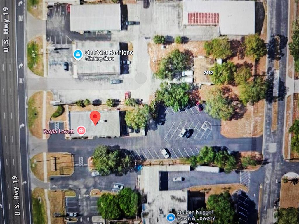 This is an aerial map view of a commercial property and its surrounding parking lot — 2404 US HIGHWAY 19, HOLIDAY, FL