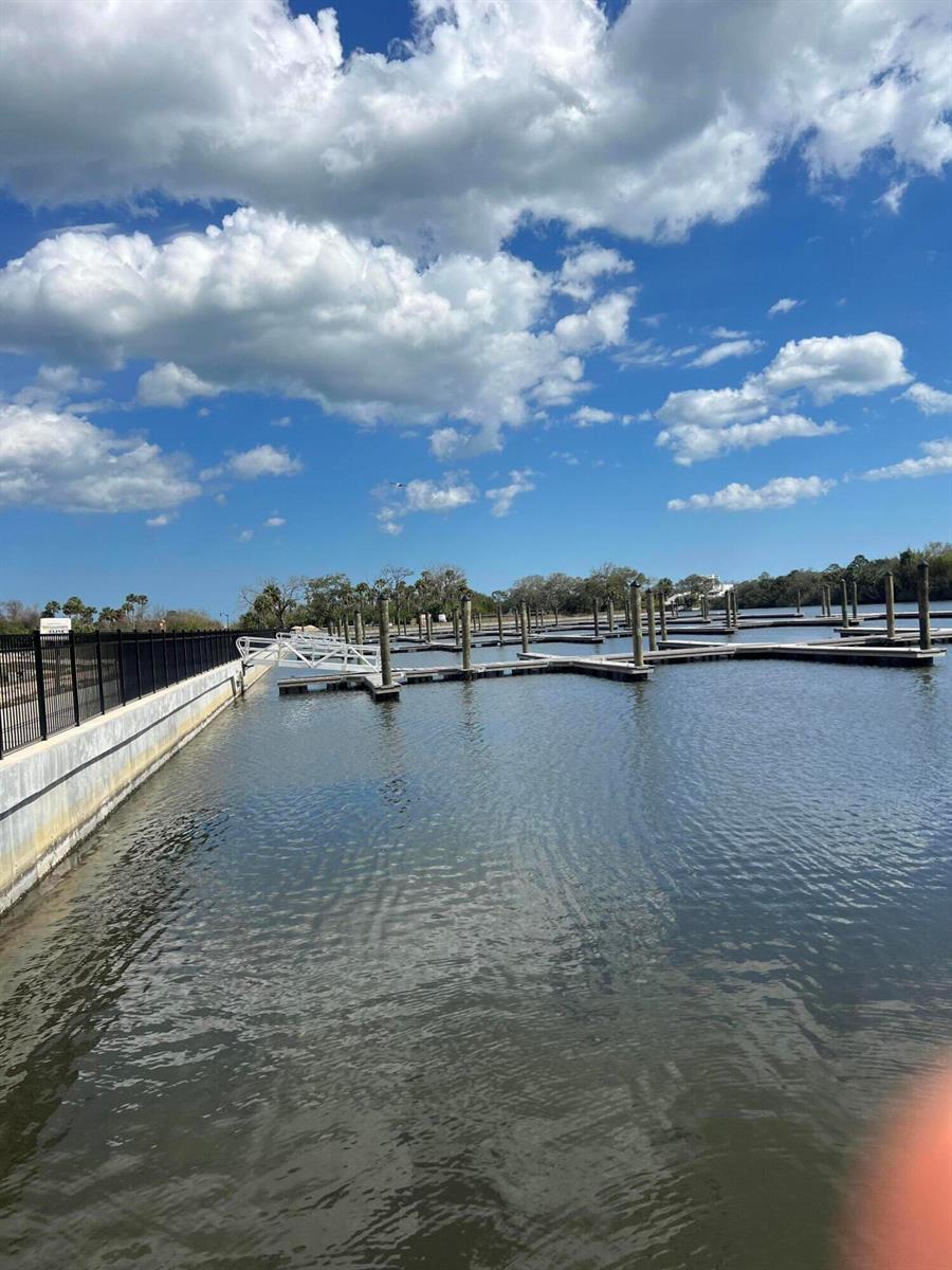 A view of a marina with wooden boat slips and a metal ramp under blue skies — 24 Del Palma Drive, Palm Coast FL 32137, PALM COAST, FL