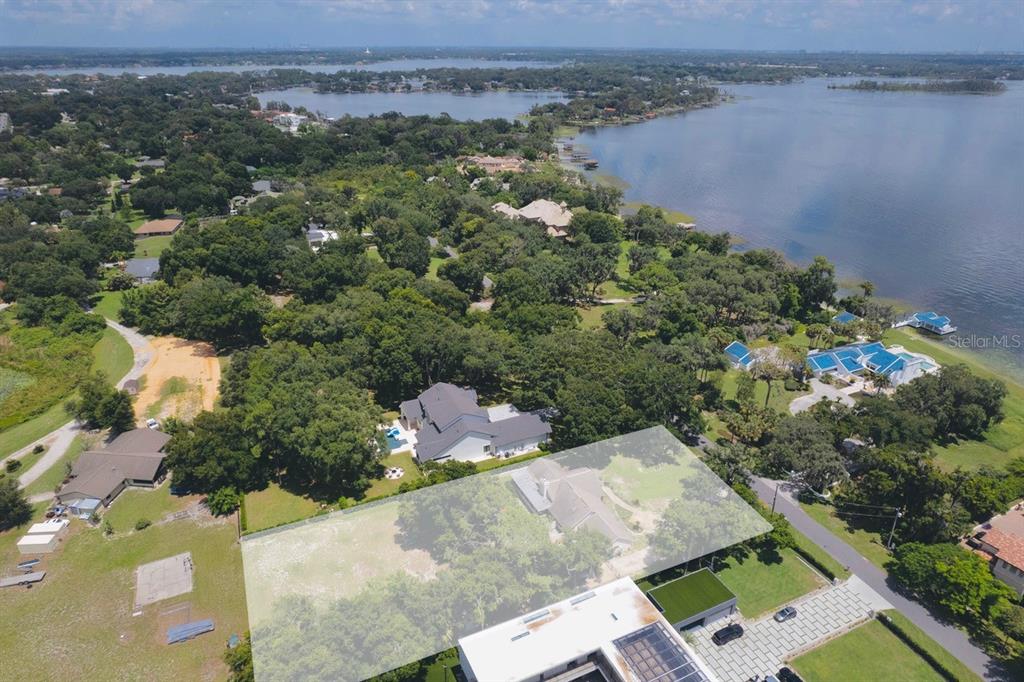 An aerial view shows a residential property with a highlighted lot near a large lake — 11923 LAKE BUTLER BOULEVARD, WINDERMERE, FL