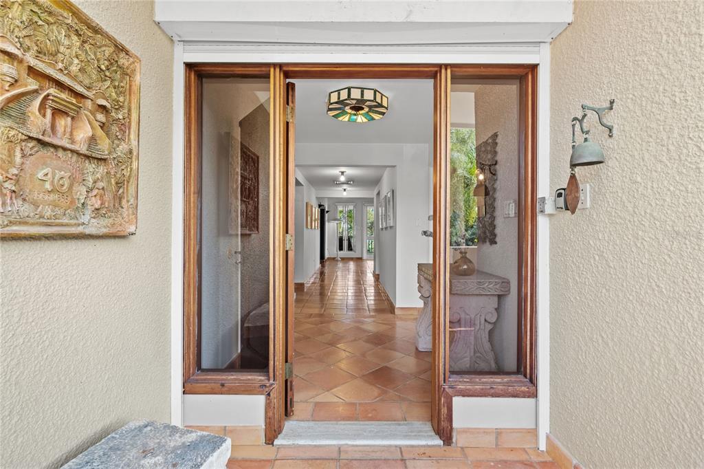 A front entryway with a wooden door, glass sidelights, and terracotta tile flooring — 32 GREEN VILLAS DRIVE UNIT 32, DORADO, PR