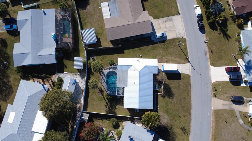 An aerial view shows several suburban houses with swimming pools and driveways along a street — 2534 WANETA DRIVE, SARASOTA, FL